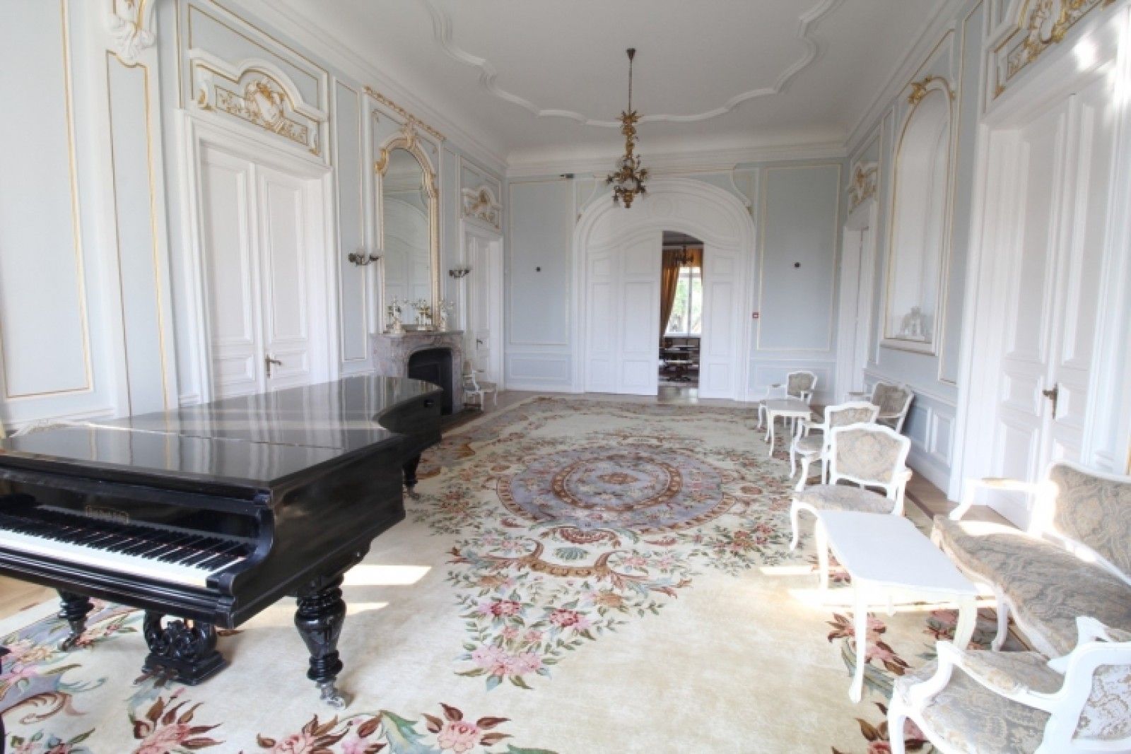Palace in Louis XIII French château style characterized by jointed brickwork, a high mansard roof with copper cladding and a clock tower.