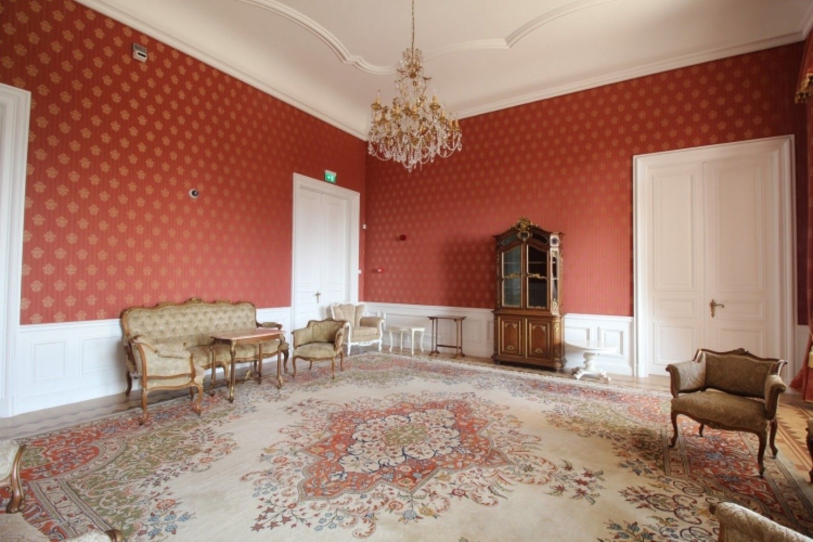 Palace in Louis XIII French château style characterized by jointed brickwork, a high mansard roof with copper cladding and a clock tower.