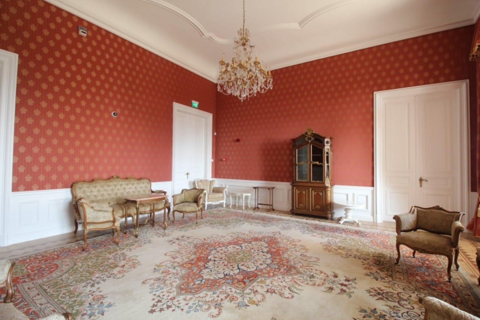 Palace in Louis XIII French château style characterized by jointed brickwork, a high mansard roof with copper cladding and a clock tower.