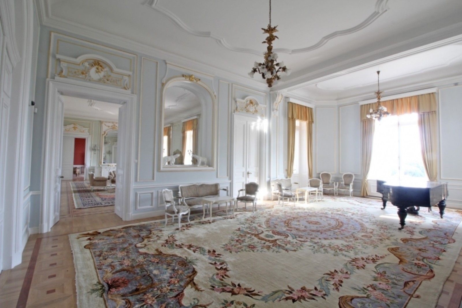 Palace in Louis XIII French château style characterized by jointed brickwork, a high mansard roof with copper cladding and a clock tower.