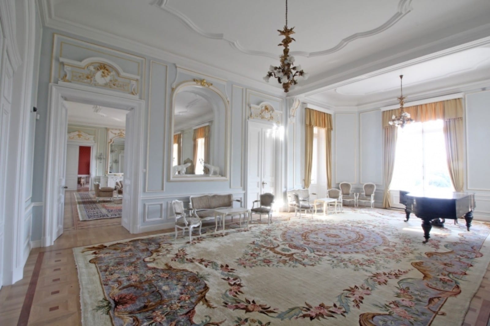 Palace in Louis XIII French château style characterized by jointed brickwork, a high mansard roof with copper cladding and a clock tower.