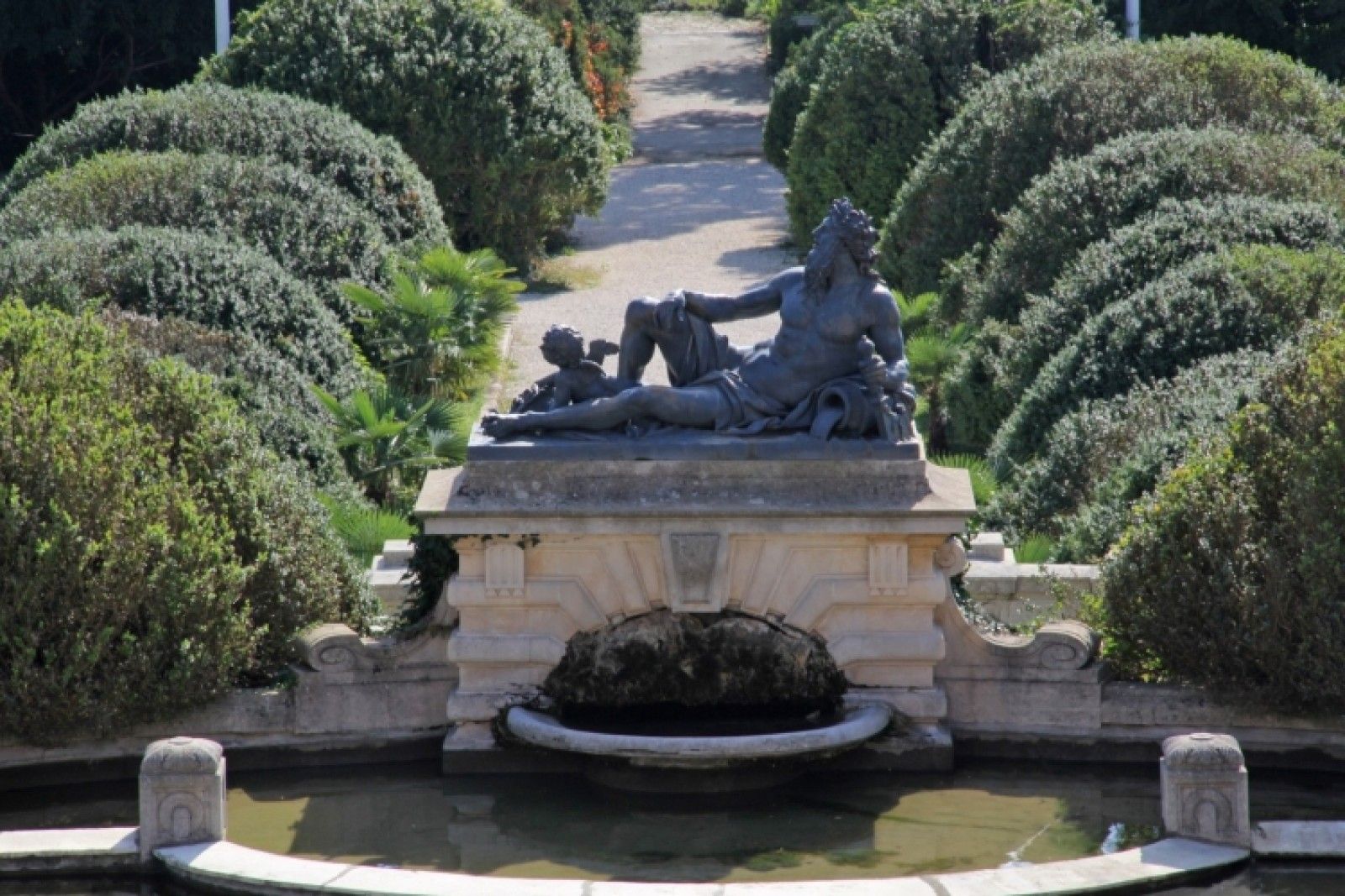 Palace in Louis XIII French château style characterized by jointed brickwork, a high mansard roof with copper cladding and a clock tower.