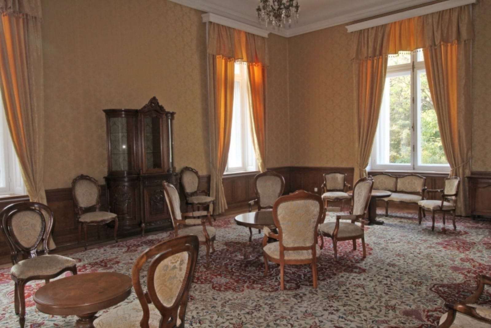 Palace in Louis XIII French château style characterized by jointed brickwork, a high mansard roof with copper cladding and a clock tower.