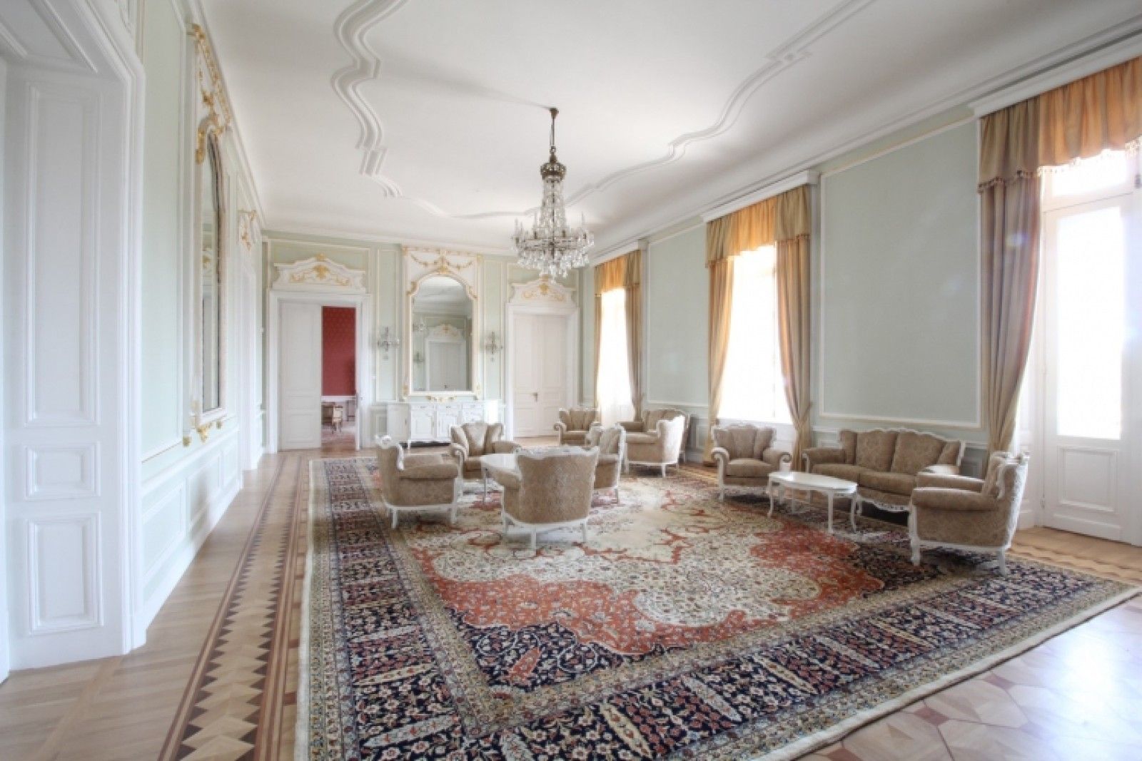 Palace in Louis XIII French château style characterized by jointed brickwork, a high mansard roof with copper cladding and a clock tower.