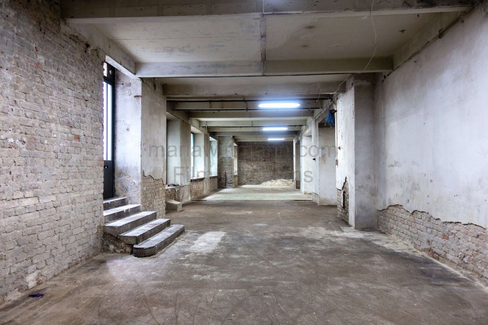 Raw Industrial Loft with Exposed Concrete and Brick - Photo 11