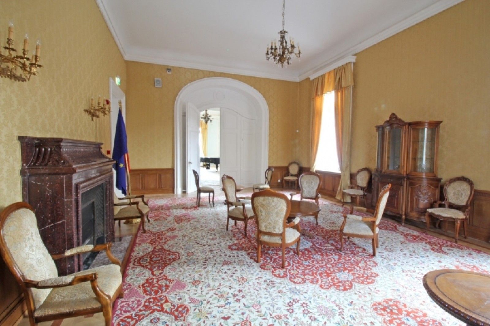 Palace in Louis XIII French château style characterized by jointed brickwork, a high mansard roof with copper cladding and a clock tower.