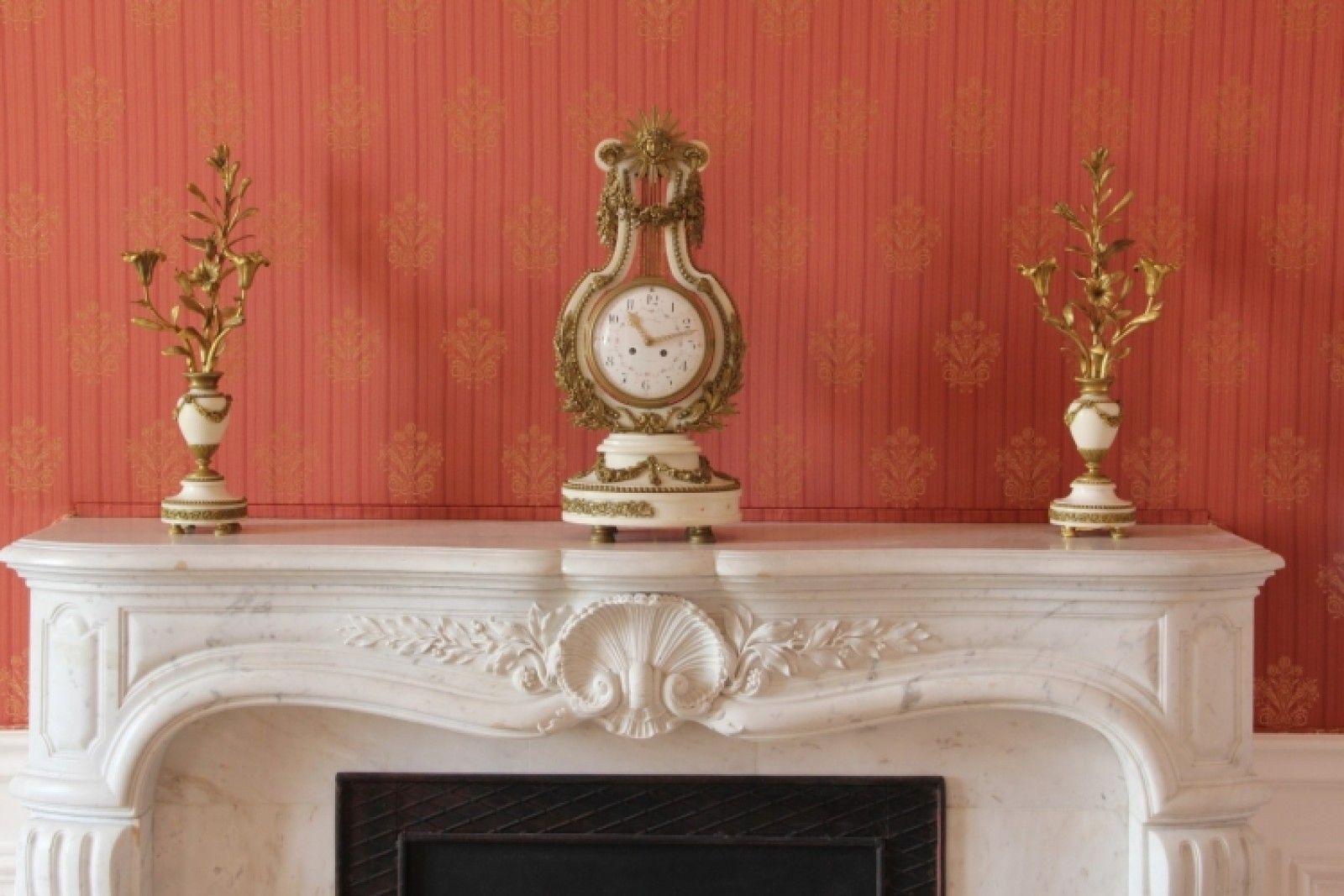 Palace in Louis XIII French château style characterized by jointed brickwork, a high mansard roof with copper cladding and a clock tower.