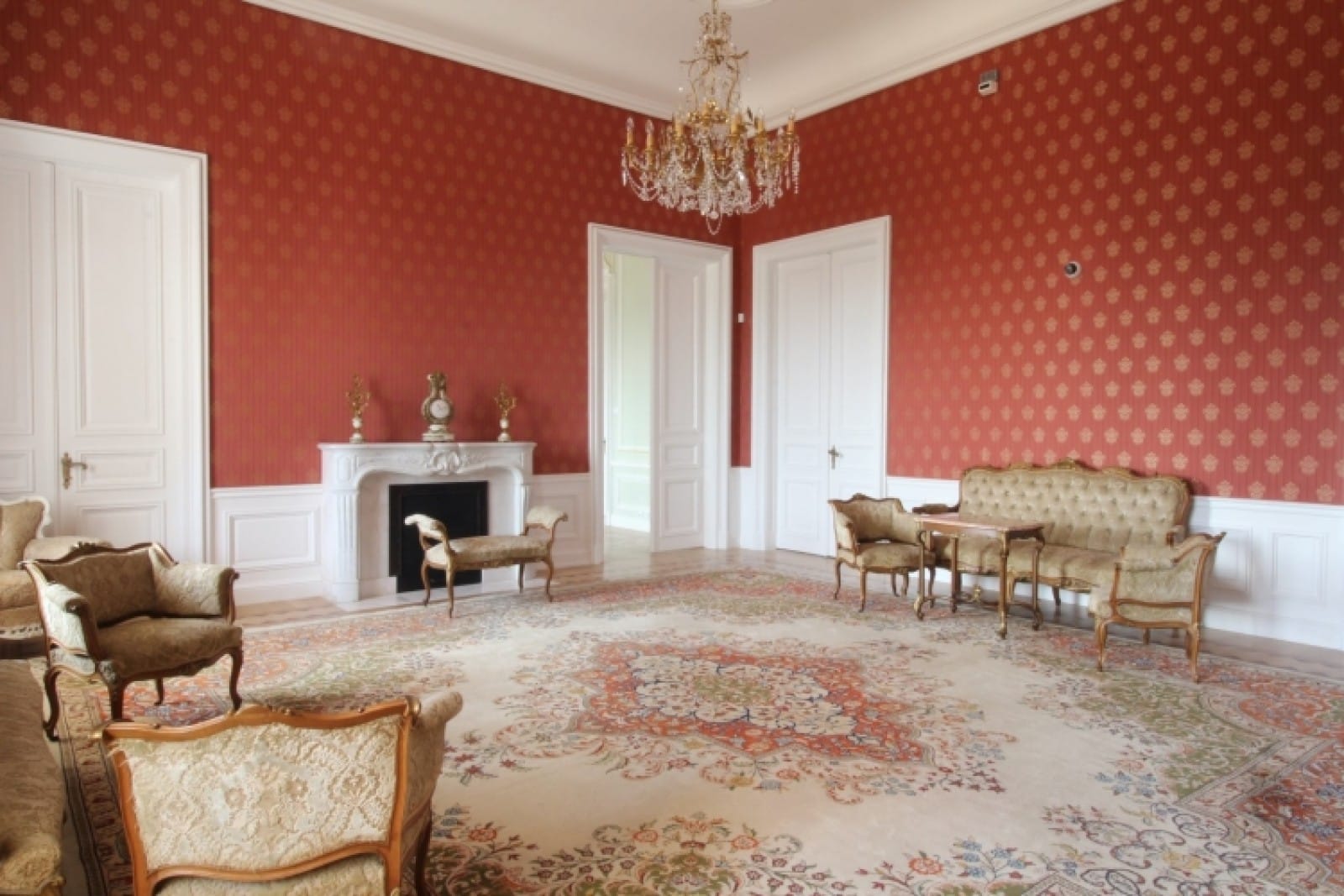 Palace in Louis XIII French château style characterized by jointed brickwork, a high mansard roof with copper cladding and a clock tower.