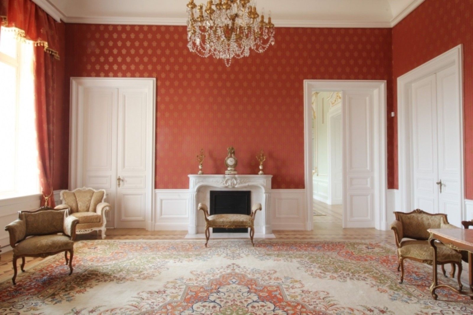 Palace in Louis XIII French château style characterized by jointed brickwork, a high mansard roof with copper cladding and a clock tower.