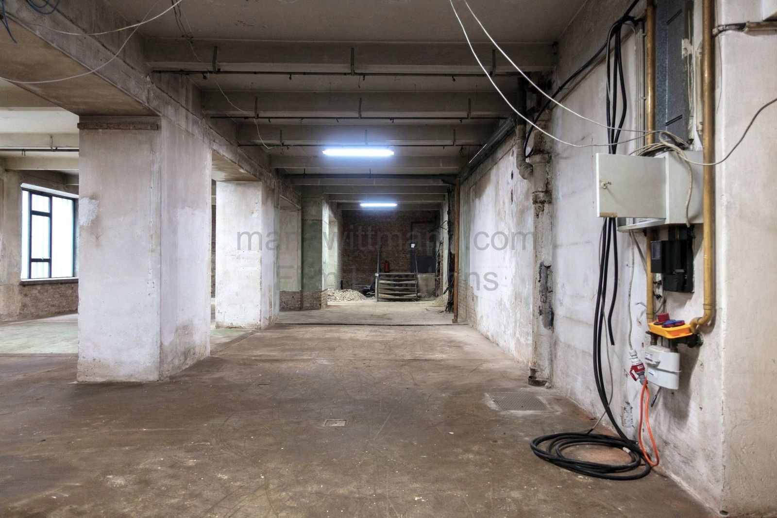 Raw Industrial Loft with Exposed Concrete and Brick - Photo 4