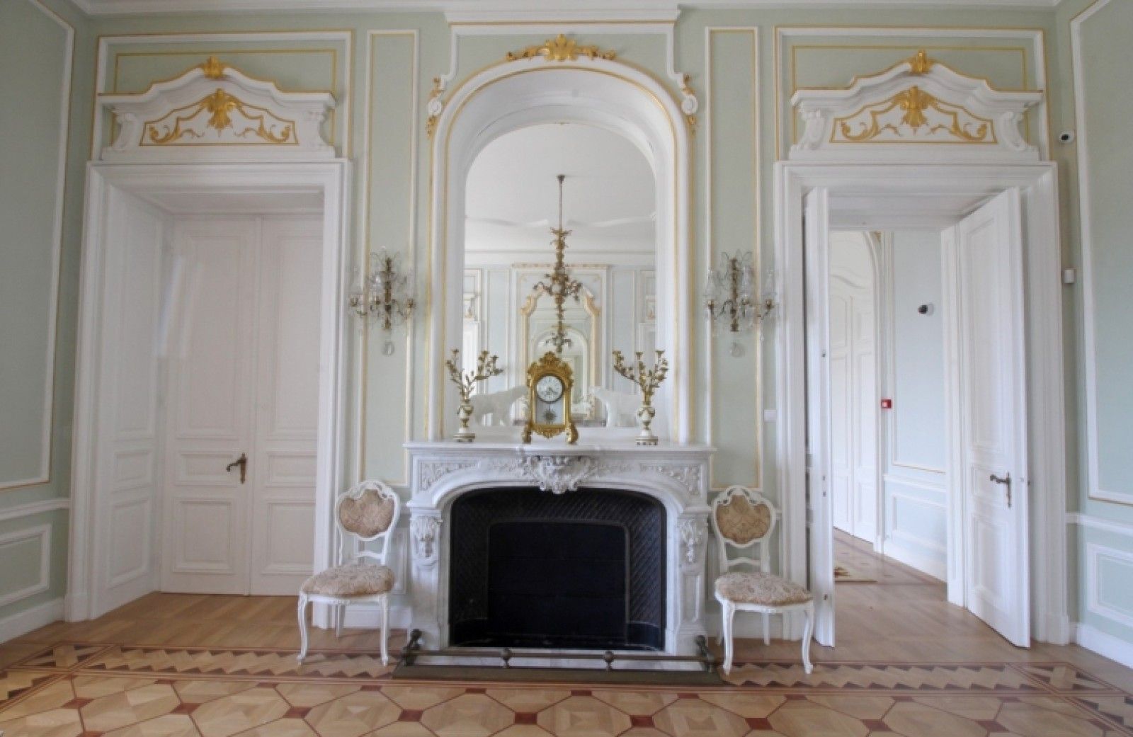 Palace in Louis XIII French château style characterized by jointed brickwork, a high mansard roof with copper cladding and a clock tower.