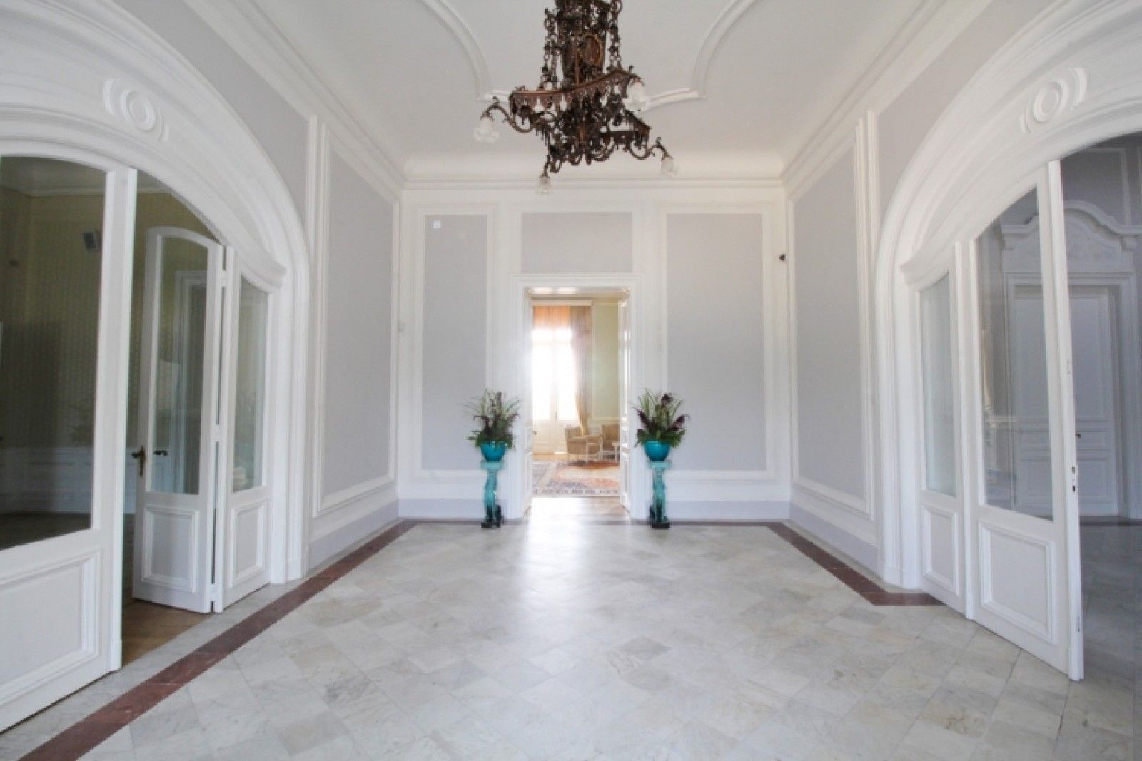 Palace in Louis XIII French château style characterized by jointed brickwork, a high mansard roof with copper cladding and a clock tower.