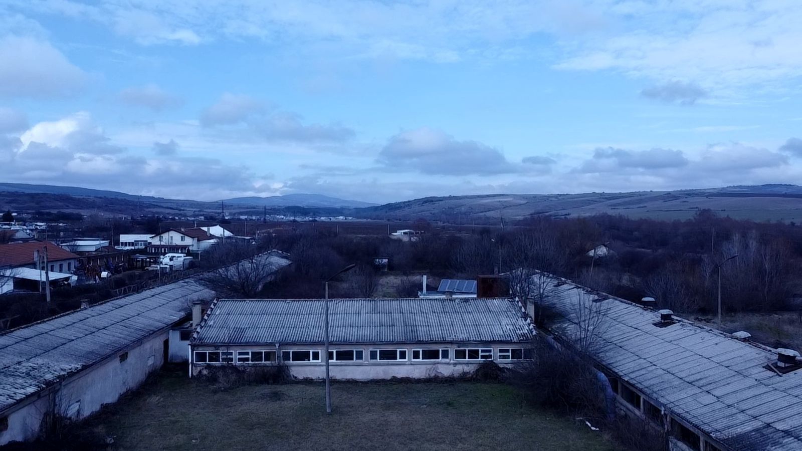 Aerial view of the industrial complex, showing the interconnected buildings forming an H-shaped layout