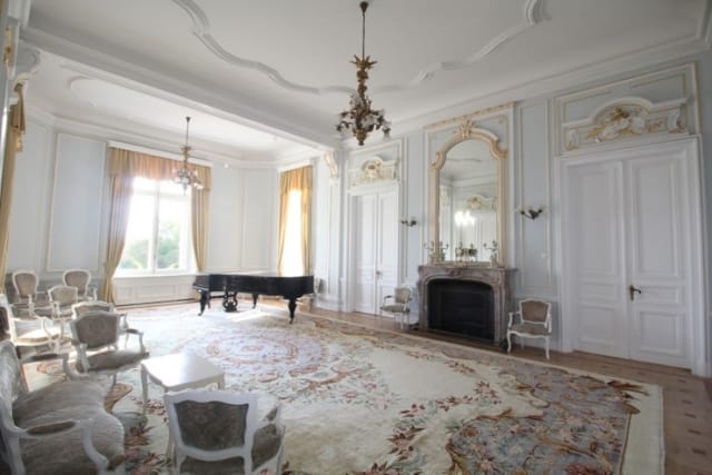 Evxinograd Palace, built in 1882, in Louis XIII French château style characterized by jointed brickwork, a high mansard roof with copper cladding and a clock tower.