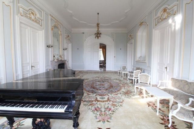 Evxinograd Palace, built in 1882, in Louis XIII French château style characterized by jointed brickwork, a high mansard roof with copper cladding and a clock tower.
