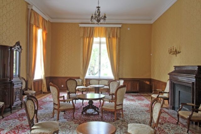 Evxinograd Palace, built in 1882, in Louis XIII French château style characterized by jointed brickwork, a high mansard roof with copper cladding and a clock tower.