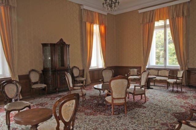 Evxinograd Palace, built in 1882, in Louis XIII French château style characterized by jointed brickwork, a high mansard roof with copper cladding and a clock tower.