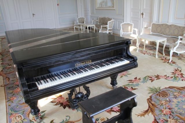 Evxinograd Palace, built in 1882, in Louis XIII French château style characterized by jointed brickwork, a high mansard roof with copper cladding and a clock tower.