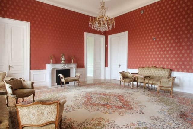 Evxinograd Palace, built in 1882, in Louis XIII French château style characterized by jointed brickwork, a high mansard roof with copper cladding and a clock tower.