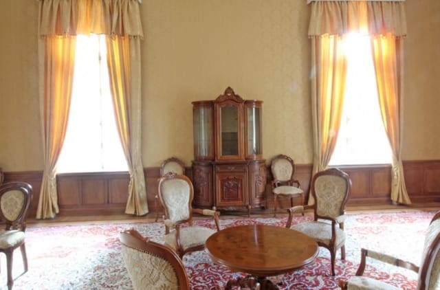 Evxinograd Palace, built in 1882, in Louis XIII French château style characterized by jointed brickwork, a high mansard roof with copper cladding and a clock tower.