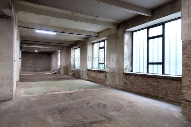 Raw Industrial Loft with Exposed Concrete and Brick