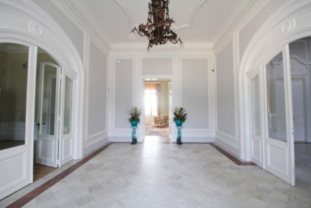 Evxinograd Palace, built in 1882, in Louis XIII French château style characterized by jointed brickwork, a high mansard roof with copper cladding and a clock tower.