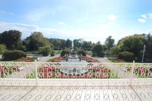 Evxinograd Palace, built in 1882, in Louis XIII French château style characterized by jointed brickwork, a high mansard roof with copper cladding and a clock tower.