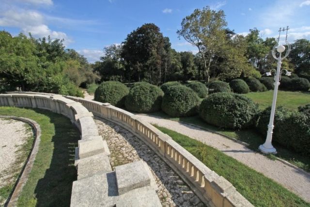 Evxinograd Palace, built in 1882, in Louis XIII French château style characterized by jointed brickwork, a high mansard roof with copper cladding and a clock tower.