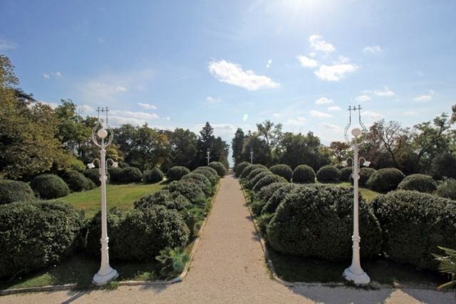 Evxinograd Palace, built in 1882, in Louis XIII French château style characterized by jointed brickwork, a high mansard roof with copper cladding and a clock tower.