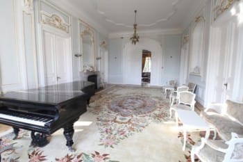 Evxinograd Palace, built in 1882, in Louis XIII French château style characterized by jointed brickwork, a high mansard roof with copper cladding and a clock tower.