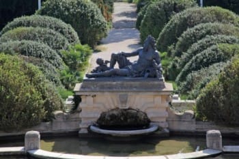 Evxinograd Palace, built in 1882, in Louis XIII French château style characterized by jointed brickwork, a high mansard roof with copper cladding and a clock tower.