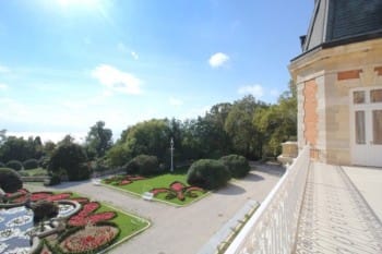 Evxinograd Palace, built in 1882, in Louis XIII French château style characterized by jointed brickwork, a high mansard roof with copper cladding and a clock tower.